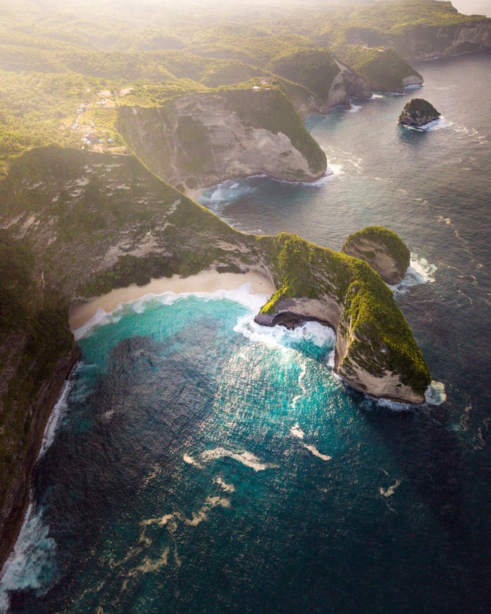 Home Stunning aerial view of Bali's coastline with turquoise waters and lush cliffs.