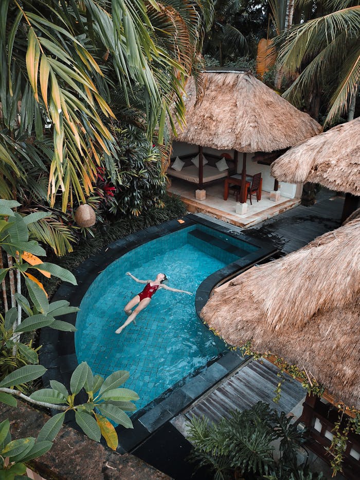 Crafting Captivating Headlines: Your awesome post title goes here A woman enjoying leisure time floating in a tropical resort pool surrounded by lush greenery.